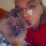 Wendy joined the competition — help win amazing prizes! blanket, casual, cat, choker, closeup, comfort, cozy, face, fluffy_cat, furry_pet, glasses, home, indoor, person, pet, portrait, red_clothing, relaxed, snuggling, warm_light