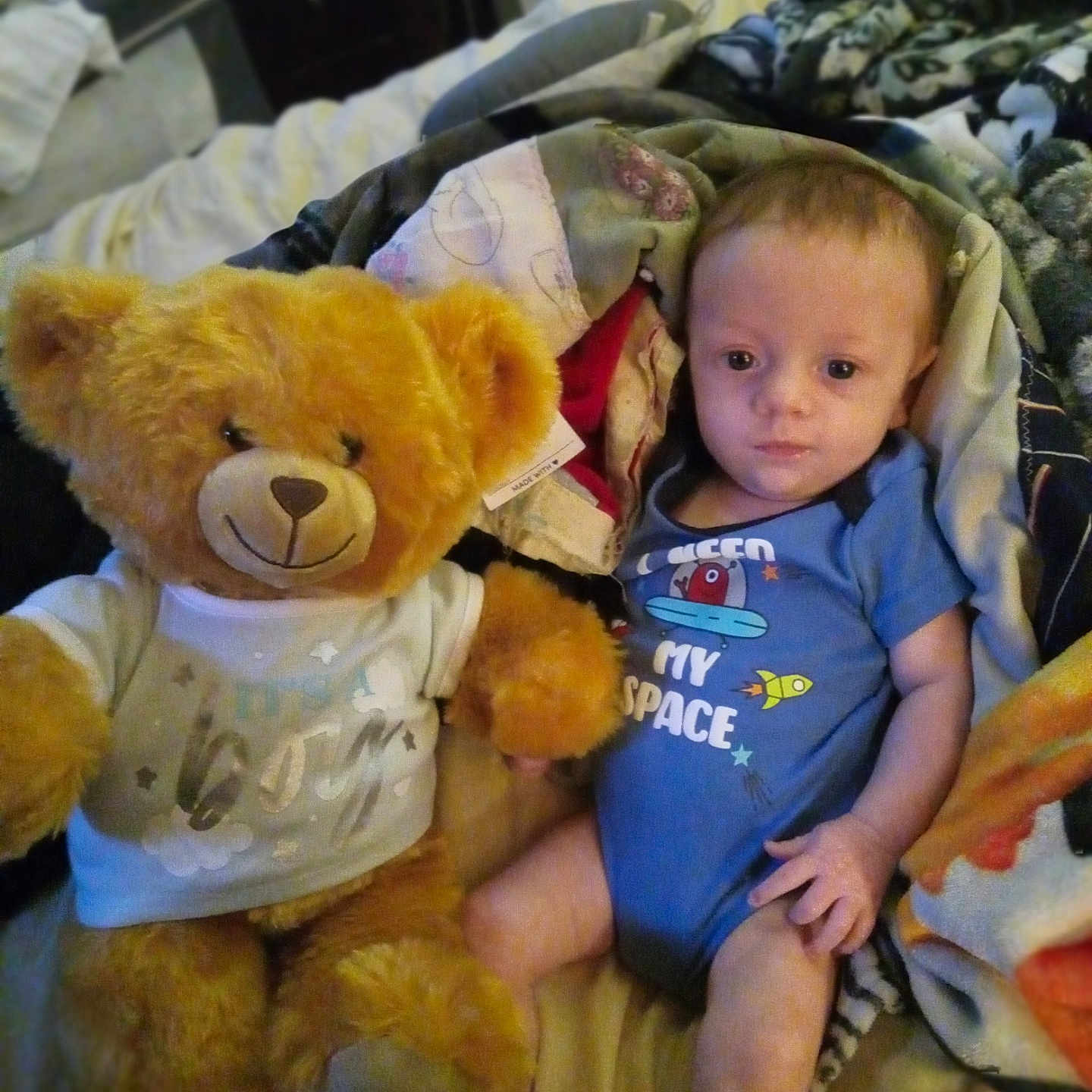 Noah joined the competition — help win amazing prizes! baby, bed, bedroom, blanket, clothing, couch, cushion, face, furniture, head, homedecor, indoors, person, photography, plush, portrait, room, t_shirt, teddybear, toy