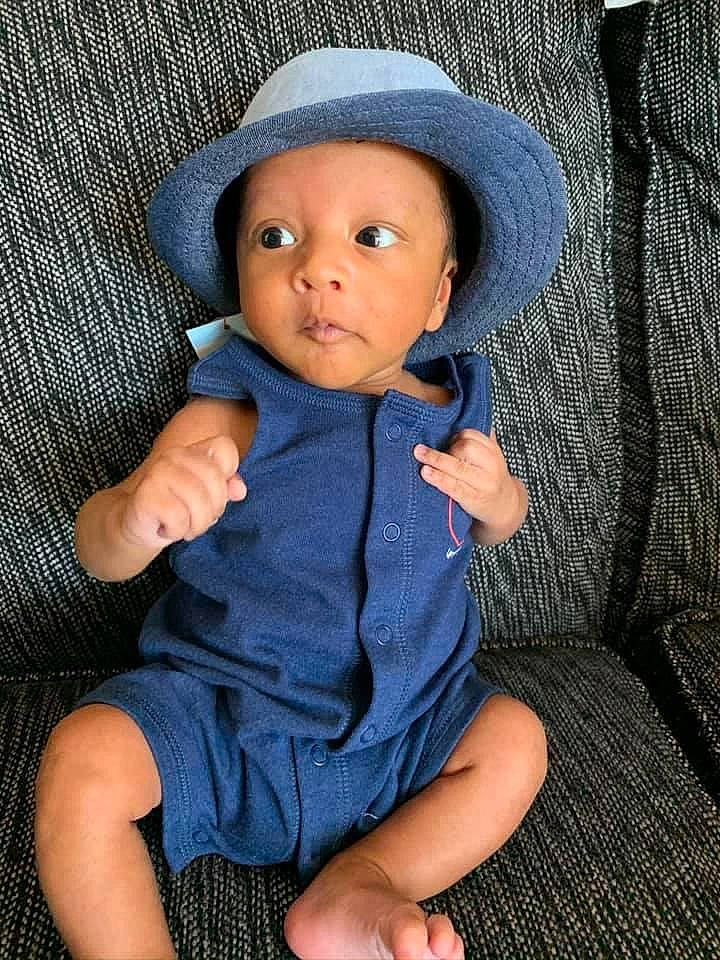 Micheal joined the competition — help win amazing prizes! baby, blue, cheek, child, doll, hat, headgear, headwear, outerwear, person, sitting, sleeve, toddler