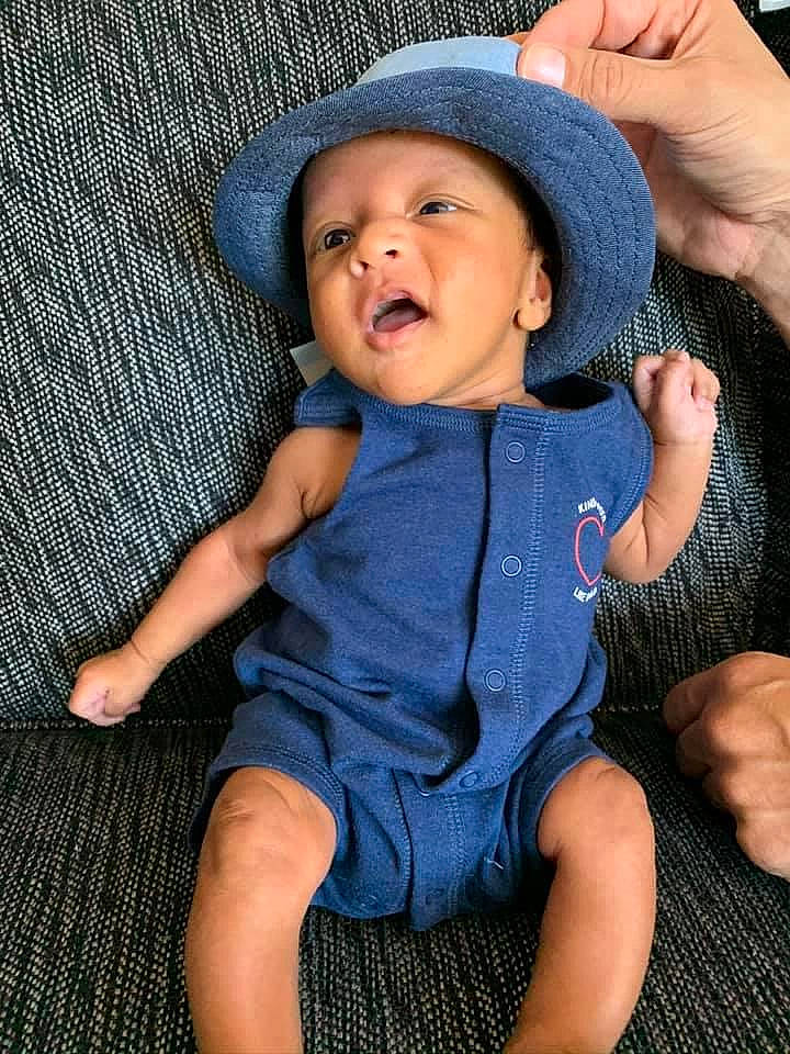 Micheal joined the competition — help win amazing prizes! baby, blue, cheek, child, fashion_accessory, finger, fun, hand, hat, headgear, headwear, person, photography, sitting, skin, smile, sun_hat, toddler, vacation