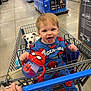 aisle, blue, child, clothing, dog, floor, hand, happy, indoor, person, pet, puppy, retail, shopping_cart, sippy_cup, smiling, spiderman, store, toddler, toy