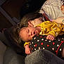Elianna is registered to the contest to win money with this photo: baby, sleeping, yellow_clothing, tattoos, adult, glasses, pillow, portrait, heart_pattern, black_clothing, indoor, couch, cozy, resting, person, hand, bedroom, blanket, skin, relaxation