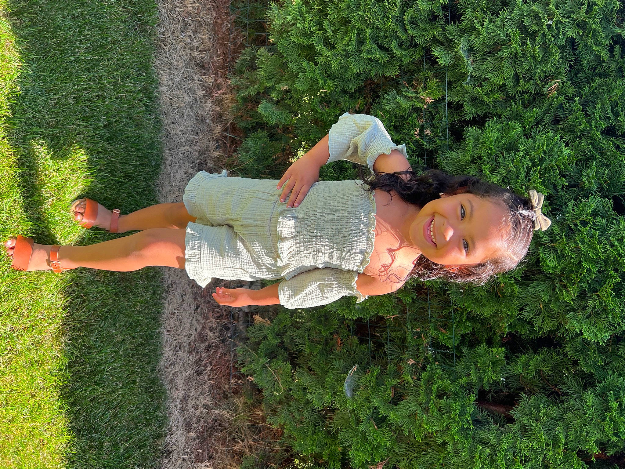 Melanie is registered to the contest to win money with this photo: elbow, fun, garden, grass, grass_family, grassland, groundcover, happy, human_leg, joy, landscape, lawn, leisure, people_in_nature, person, plant, recreation, shrub, thigh, tree