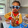 toddler, child, sunglasses, costume, sheriff_badge, kitchen, countertop, snacks, chips_ahoy, bowl, food, hand, window, cabinet, person, playful, pose, blue_pants, red_cuffs, indoors
