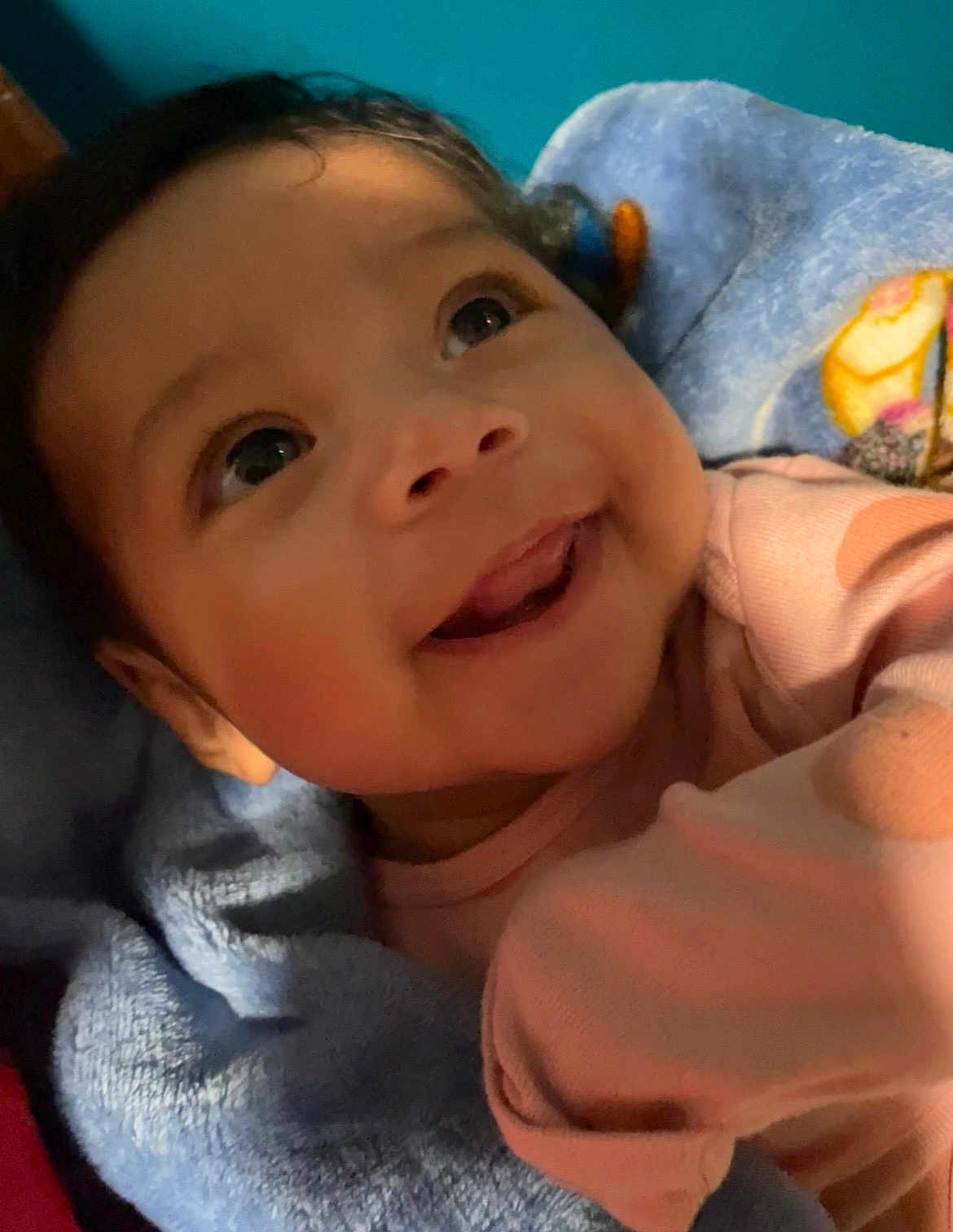Zoey is registered to the contest to win money with this photo: baby, child, smiling, face, eyes, blanket, clothing, infant, portrait, cute, happy, indoors, person, blue, pink, soft, young, skin, expression, closeup