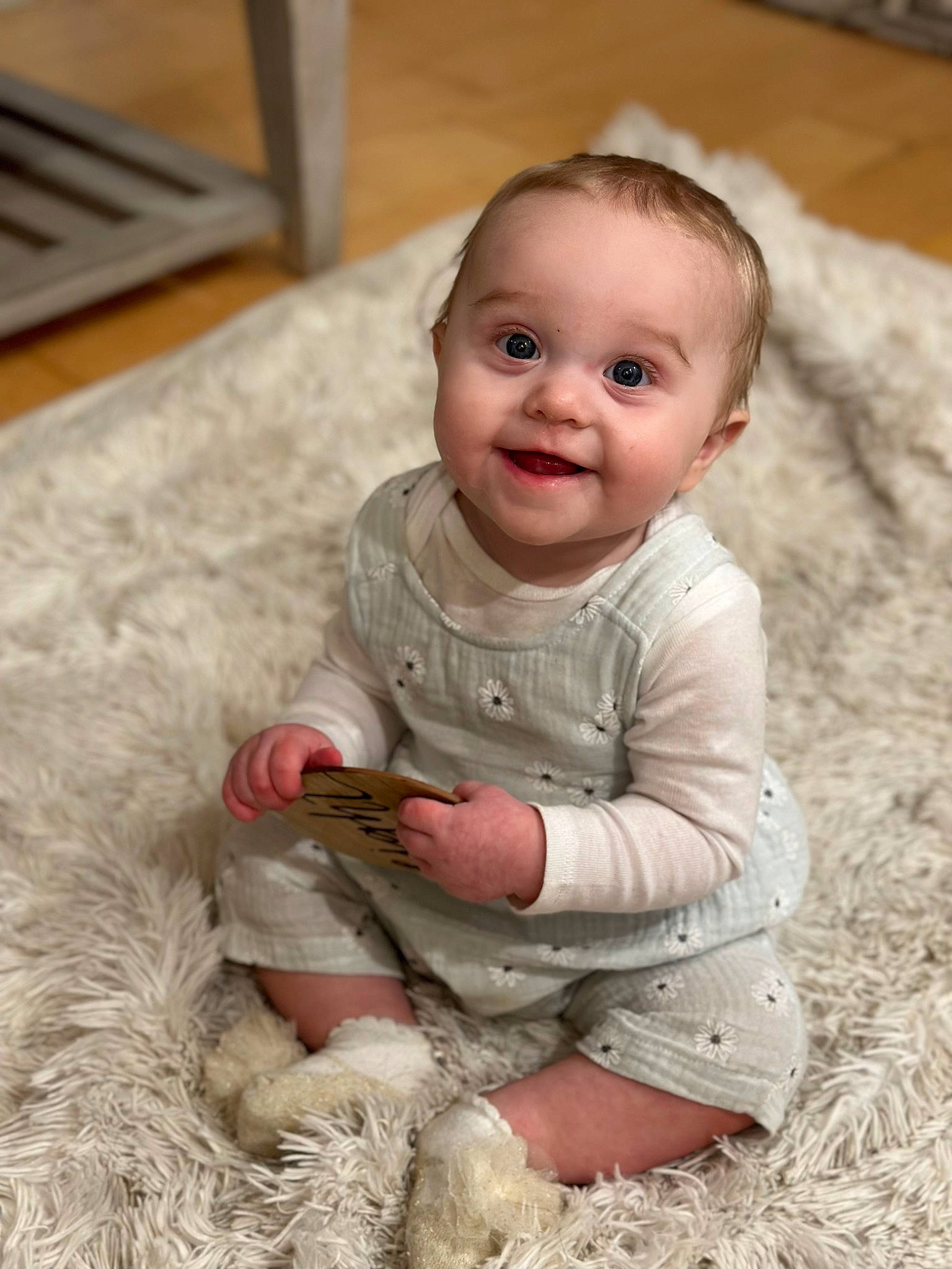 Kylie joined the competition — help win amazing prizes! baby, baby_toddler_clothing, cheek, dress, eye, face, facial_expression, flooring, fun, grass, happy, hardwood, head, iris, joy, person, sitting, skin, sleeve, smile