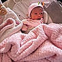 Melanie is registered to the contest to win money with this photo: baby, blanket, pink, baby_seat, hat, soft_toy, cloud, infant, cute, warm, cozy, child, face, newborn, resting, clothing, soft_texture, indoor, sleepwear, adorable