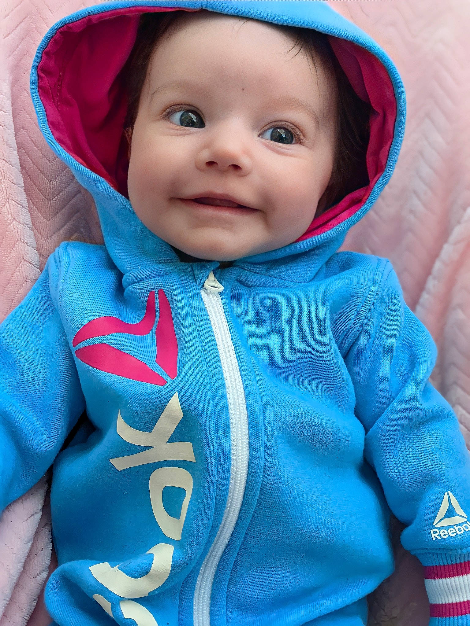 Arya is registered to the contest to win money with this photo: azure, baby, baby_toddler_clothing, cheek, eye, eyebrow, face, happy, head, headgear, headwear, iris, joy, nose, outerwear, person, pink, red, skin, sleeve