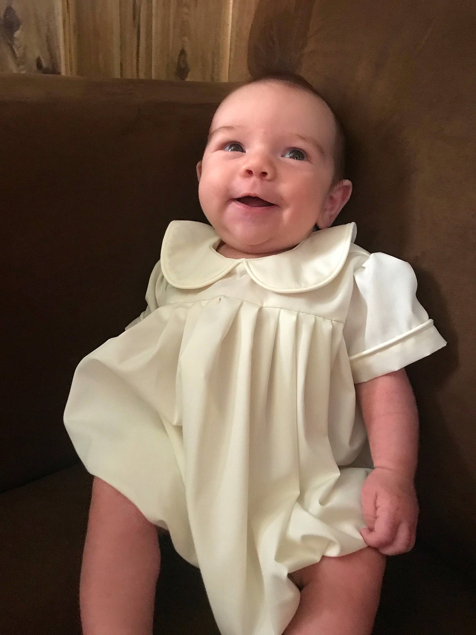 Hank is registered to the contest to win money with this photo: baby, baby_toddler_clothing, cheek, child, dress, face, facial_expression, head, mouth, person, product, sitting, skin, sleeve, smile, toddler, white