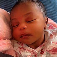 Elijah is registered to the contest to win money with this photo: baby, sleeping, infant, blanket, pink, floral_clothing, face, peaceful, cute, closeup, newborn, soft, resting, portrait, child, indoors, young, pacifier, cozy, comfort