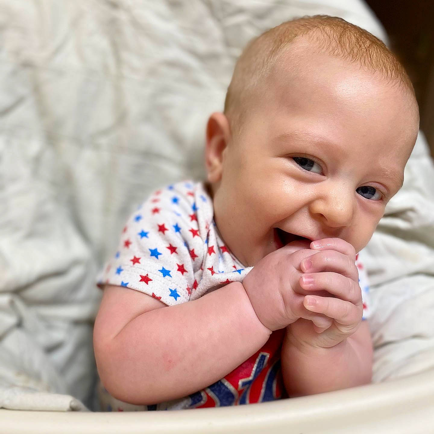 Jordan is registered to the contest to win money with this photo: baby, baby_making_funny_faces, cheek, child, ear, eye, face, finger, hand, head, lip, mouth, nose, person, skin, thumb, toddler, tummy_time