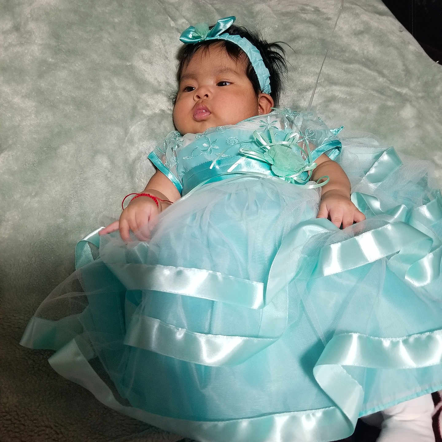 Alida joined the competition — help win amazing prizes! adorable, baby, blanket, blue_dress, child, clothing, cute, dress, fabric, fashion, headband, headwear, indoor, infant, laying_down, person, portrait, resting, soft_texture, young_child