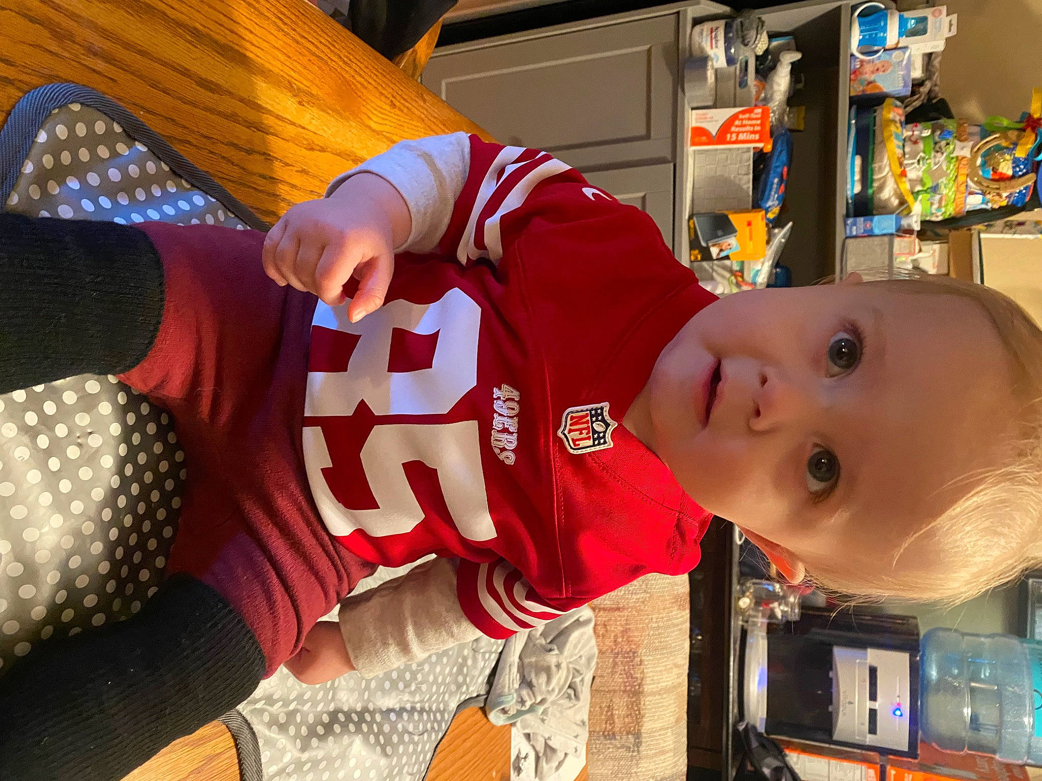 Nolan is registered to the contest to win money with this photo: baby, baby_toddler_clothing, carmine, child, cool, flooring, fun, hat, human_leg, knee, leisure, pattern, person, room, sleeve, sock, sportswear, surprise, t_shirt, thigh