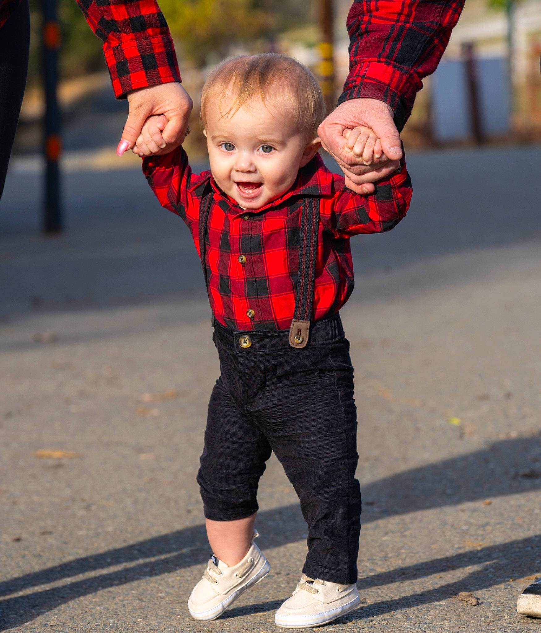 Nolan is registered to the contest to win money with this photo: baby_toddler_clothing, clothing, face, gesture, happy, head, orange, outerwear, people, person, plaid, plant, red, sleeve, smile, standing, tartan, textile, toddler, tree