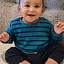 baby, bright, carpet, casual, child, clothing, cute, face, foot, happy, indoors, person, playful, portrait, sitting, skin, smiling, striped_shirt, toy, young_child