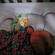 Irene joined the competition — help win amazing prizes! baby, sleeping, floral_clothing, infant, patterned_fabric, bed, blanket, head, person, resting, indoors, soft_lighting, close_up, peaceful, child, small_hand, colorful, fabric, quiet, nap