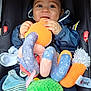 Ayden participe au concours pour gagner de l'argent avec cette photo : baby, blanket, blue_jacket, car_seat, child, clothing, colorful, comfort, cute, face, hands, happy, indoor, infant, octopus_toy, playful, plush_toy, seat_belt, smiling, soft_toys