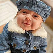 éden a rejoint le concours — aidez-le/la à gagner de superbes lots ! baby, infant, smile, hat, cap, corduroy, coat, fur_collar, buttons, portrait, closeup, cheeks, eyes, cute, cozy, indoor, soft_lighting, fashion, person, headwear