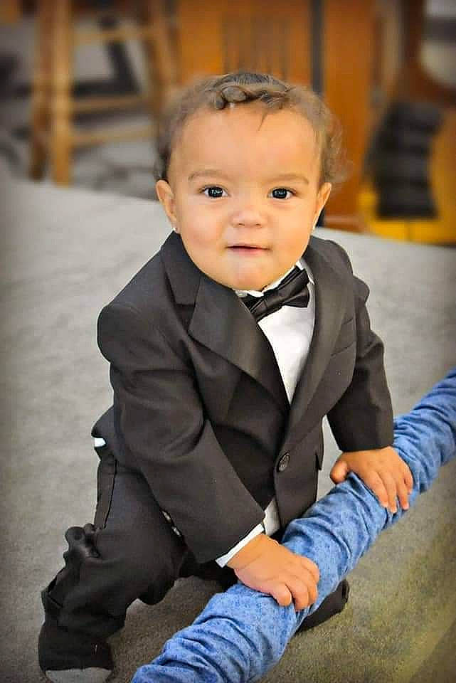 Brenton is registered to the contest to win money with this photo: baby, cheek, child, child_model, formal_wear, outerwear, person, photography, sitting, smile, standing, suit, toddler, tuxedo