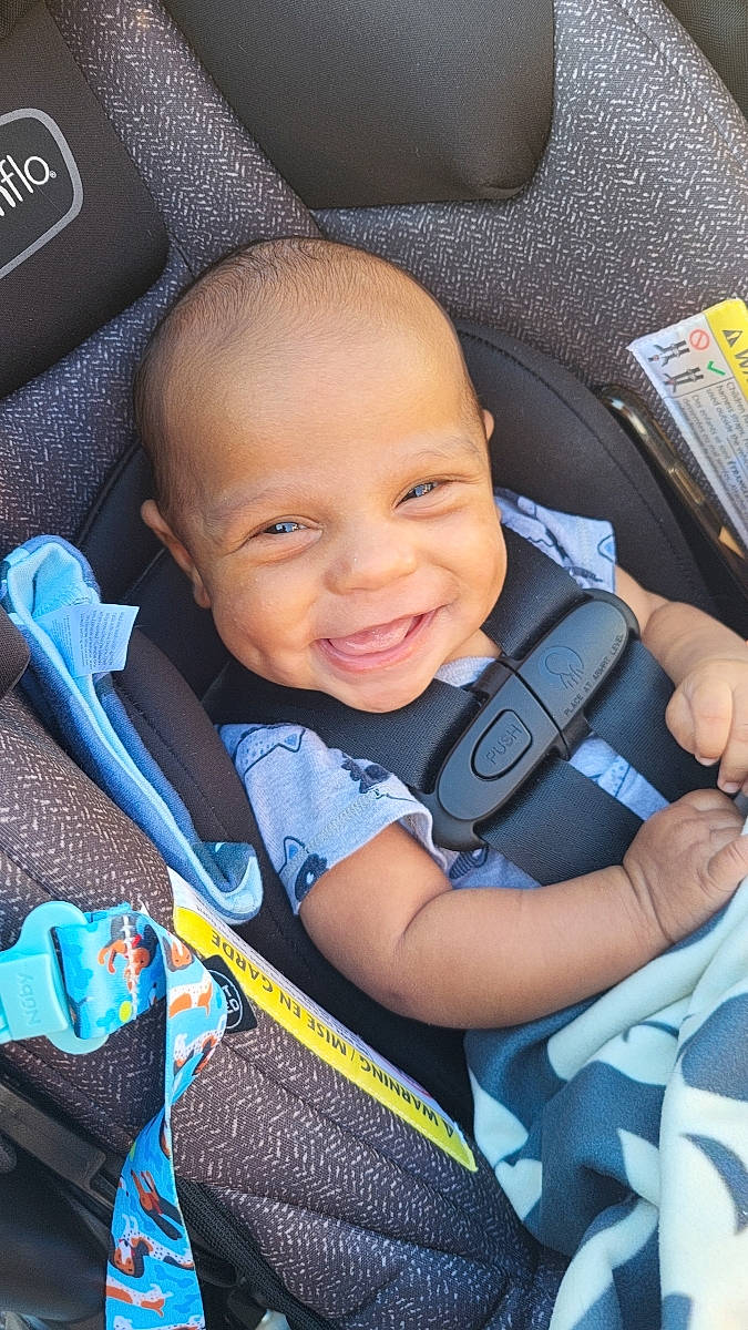 Ellis is registered to the contest to win money with this photo: auto_part, automotive_design, azure, baby, baby_carriage, baby_products, baby_toddler_clothing, beauty, car_seat, car_seat_cover, child, comfort, electric_blue, family_car, finger, happy, joy, person, product, smile