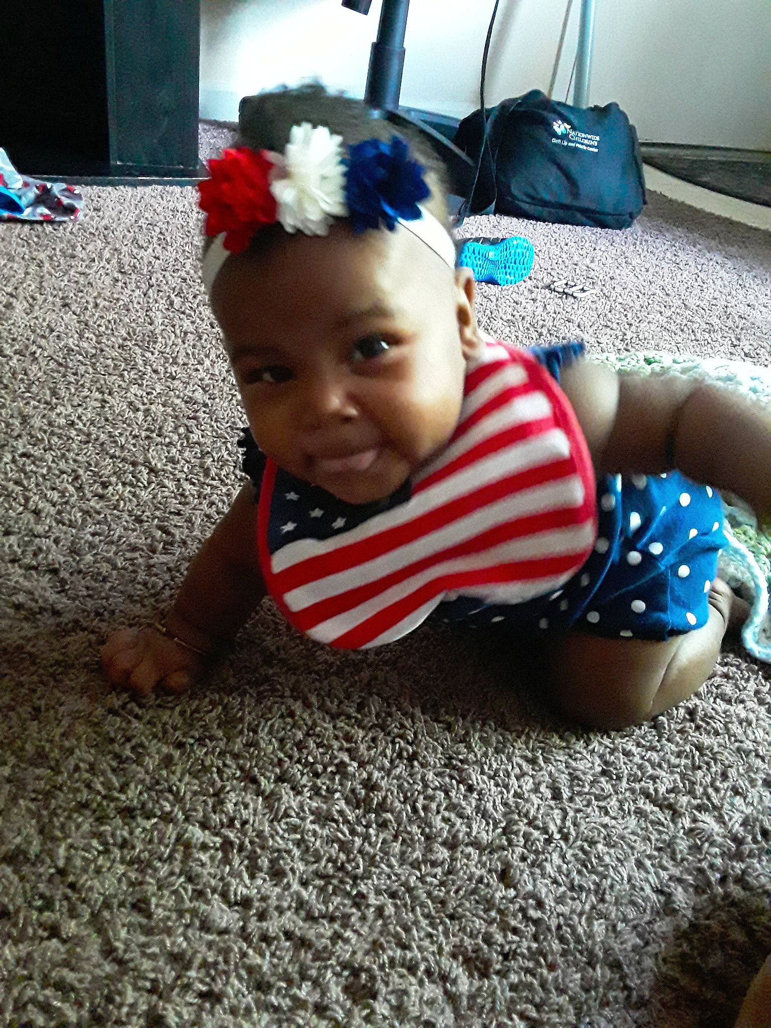 Arden is registered to the contest to win money with this photo: baby, cheek, child, crawling, ear, electronic_device, fashion_accessory, floor, flooring, fun, hair_accessory, head, headband, headgear, person, play, skin, smile, technology, toddler