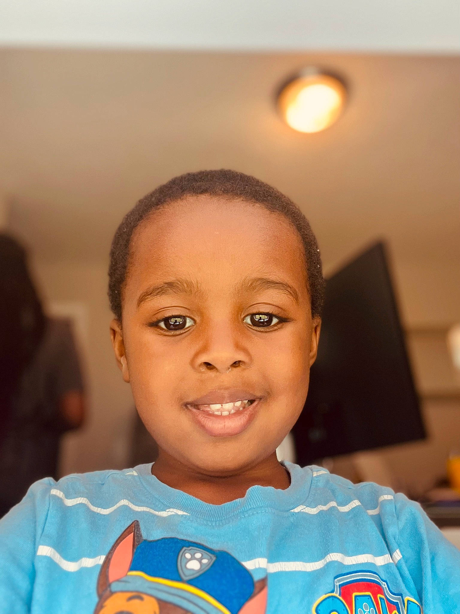 Landen is registered to the contest to win money with this photo: cheek, child, electric_blue, eye, eyebrow, forehead, fun, happy, human_body, iris, jersey, joy, nose, person, player, room, smile, sports_uniform, sportswear, t_shirt