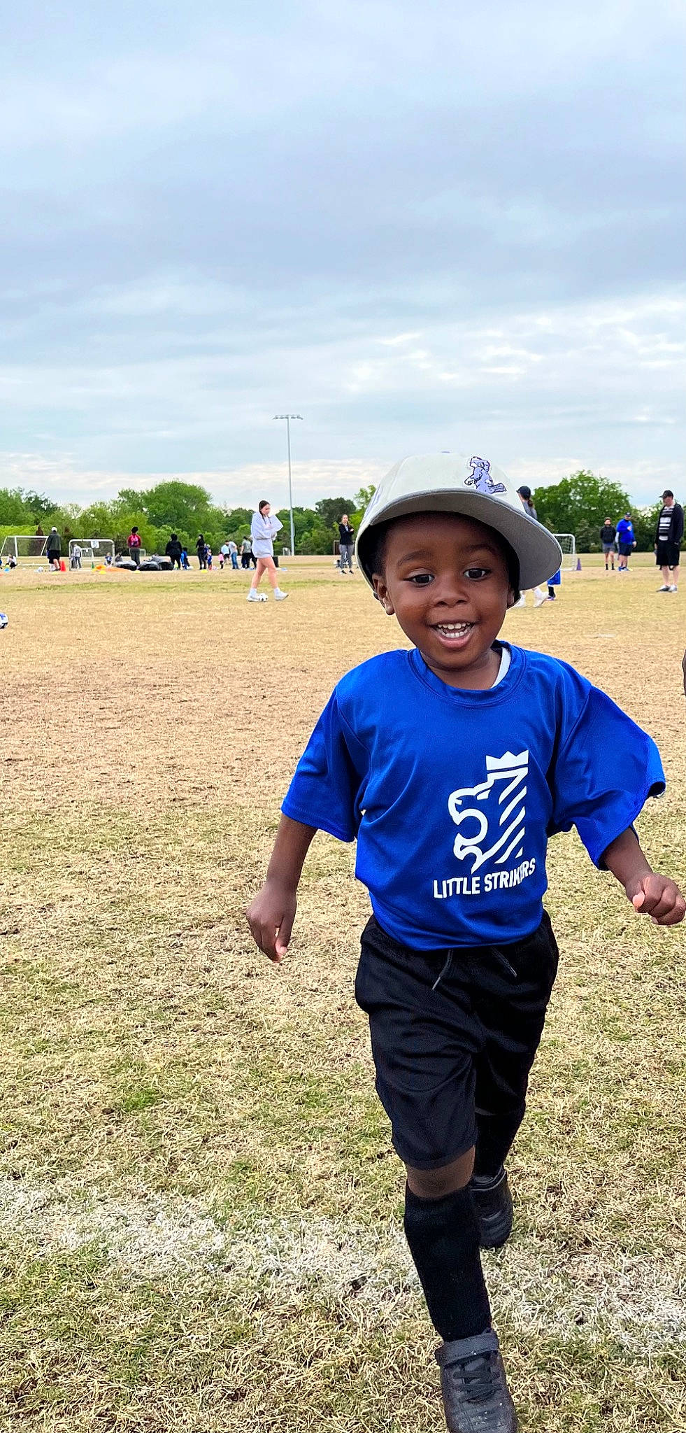 Landen is registered to the contest to win money with this photo: baseball_cap, cap, cloud, competition_event, electric_blue, grass, grassland, happy, hat, joy, landscape, leisure, people_in_nature, person, player, recreation, sky, smile, sports, sun_hat