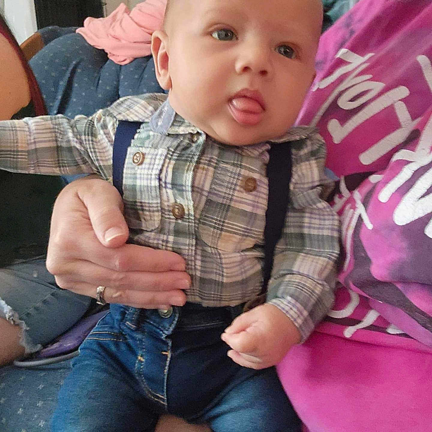 Hudson is registered to the contest to win money with this photo: accessories, baby, bodypart, clothing, coat, couch, cushion, face, finger, furniture, head, homedecor, jacket, jeans, pants, person, photography, portrait, sitting, suspenders