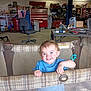 Jaxon is registered to the contest to win money with this photo: blue_shirt, chair, child, floor, garage, happy, indoor, mesh, milk_mustache, person, plaid, playpen, shelves, smiling, storage, table, toddler, tools, toy, workshop