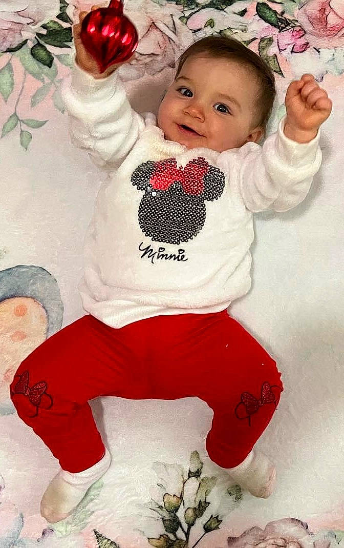 Eliana joined the competition — help win amazing prizes! arm, baby, baby_toddler_clothing, carmine, child, facial_expression, font, happy, headgear, joy, pattern, person, photograph, pink, red, sleeve, smile, sock, sportswear, thigh