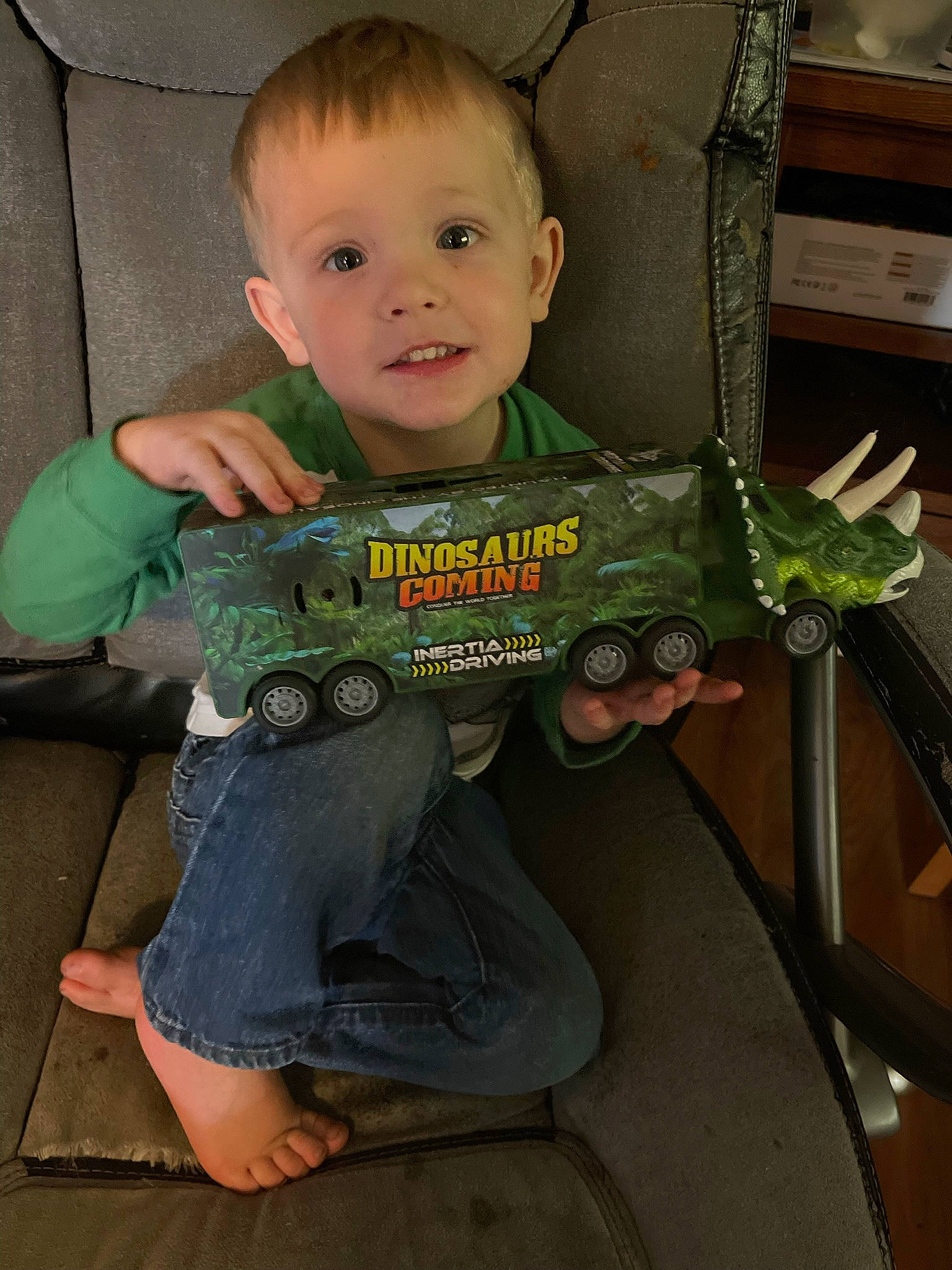 Grant is registered to the contest to win money with this photo: baby, baby_products, baby_toddler_clothing, chair, cheek, child, eye, finger, fun, iris, lap, mouth, person, reptile, room, sitting, sleeve, smile, standing, t_shirt