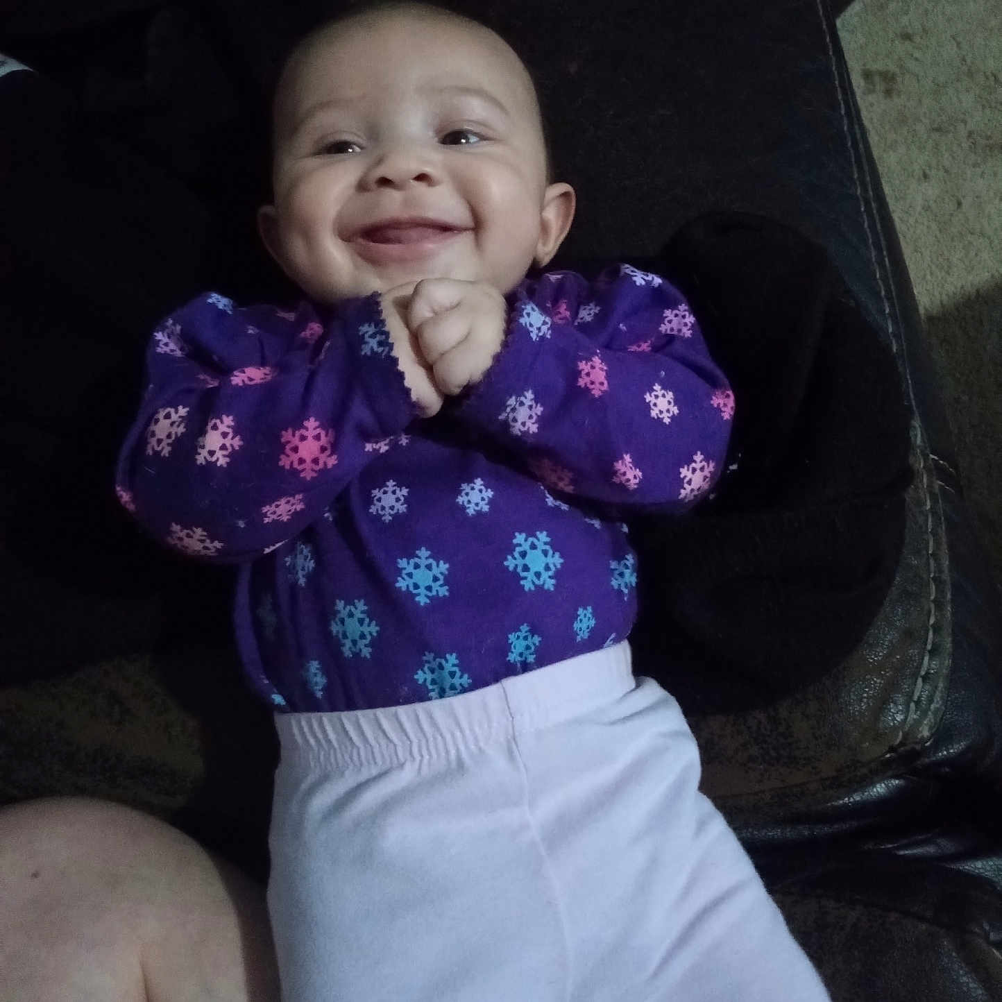 Bellarose is registered to the contest to win money with this photo: baby, bodypart, clothing, coat, cushion, face, happy, head, homedecor, jacket, laughing, mouth, pants, person, photography, portrait, shorts, sitting, smile, teeth