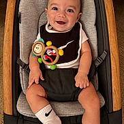 Fabian joined the competition — help win amazing prizes! baby, baby_seat, black_and_white_clothing, carpet, child, comfortable, cute, happy, indoors, infant, monkey_toy, nike, playful, portrait, seated, smiling, socks, toy, wooden_frame, young_child
