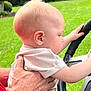 Jon Lewis joined the competition — help win amazing prizes! baby, child, hand, steering_wheel, outdoor, grass, person, curious, holding, close_up, skin, short_sleeve, adult_hand, nature, young, exploration, support, greenery, profile, daylight