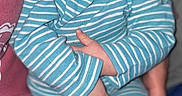 Kade joined the competition — help win amazing prizes! baby, infant, sleeping, pajamas, striped_clothing, blue, white, portrait, indoors, cuddled, held, peaceful, closed_eyes, face, hands, socks, seated, blanket, bed, family