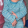 baby, infant, sleeping, pajamas, striped_clothing, blue, white, portrait, indoors, cuddled, held, peaceful, closed_eyes, face, hands, socks, seated, blanket, bed, family