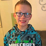 Mason joined the competition — help win amazing prizes! child, boy, smiling, glasses, braces, portrait, indoors, hoodie, minecraft, gaming, clothing, face, head, person, happy, teeth, brown_hair, seated, warm_lighting, home