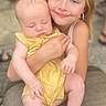 Khloe is registered to the contest to win money with this photo: baby, child, siblings, sister, sleeping, smiling, portrait, yellow_outfit, infant, family, 抱抱, outdoor, chair, seated, blonde_hair, close_up, cuddling, happy, photography, safe