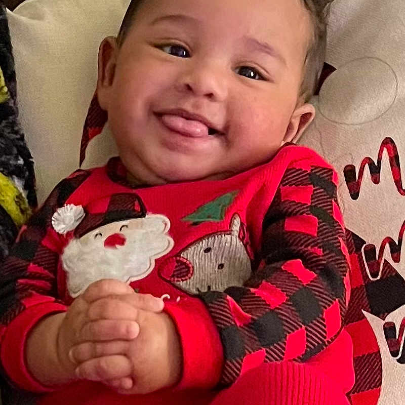 Eli is registered to the contest to win money with this photo: baby, babylaughing, clothing, coat, couch, cushion, face, furniture, happy, head, homedecor, jacket, laughing, pajamas, pants, person, photography, portrait, sitting, smile