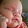 Dollyne is registered to the contest to win money with this photo: baby, sleeping, close_up, face, chubby_cheeks, hand, fist, skin, infant, peaceful, cute, young_child, floral_clothing, indoors, portrait, soft_light, pink, newborn, child, expressionless