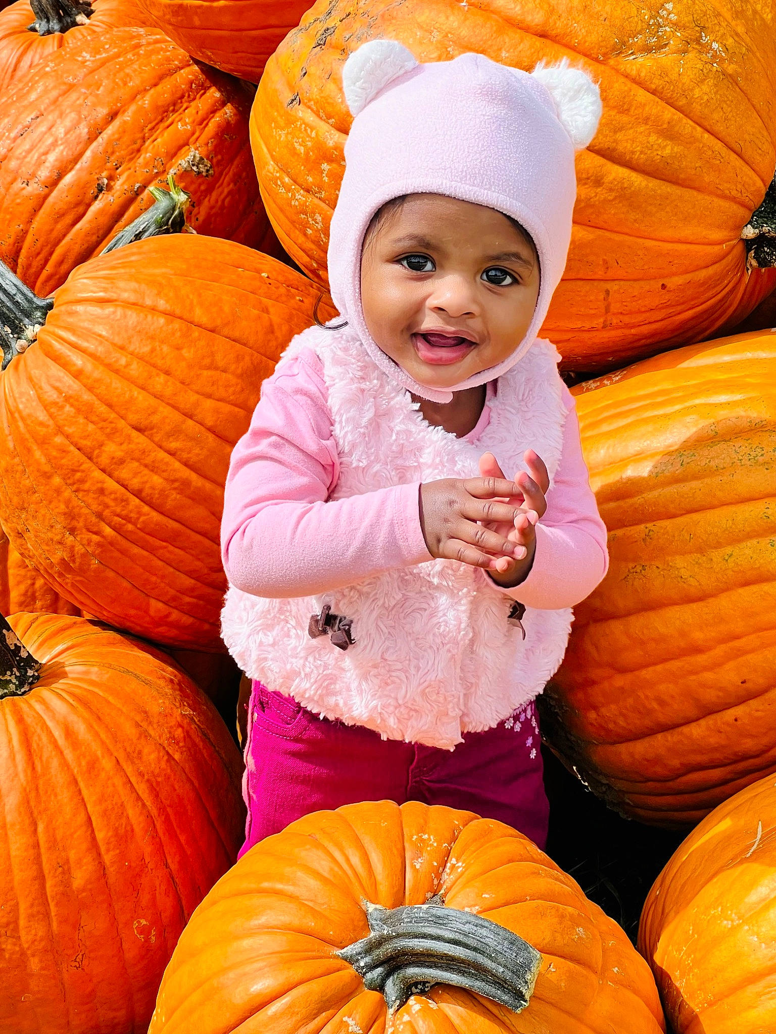 Lisa is registered to the contest to win money with this photo: calabaza, eye, facial_expression, gourd, happy, head, headwear, human_body, local_food, natural_foods, orange, organ, people_in_nature, person, photograph, plant, pumpkin, smile, squash, toddler