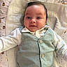 baby, infant, smile, face, vest, shirt, clothing, blanket, pattern, honey_pot, bee, lying_down, cute, child, portrait, indoor, happy, young, person, soft