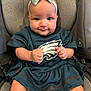 baby, infant, child, car_seat, headband, bow, sportswear, teal_dress, smile, fists, cute, portrait, indoors, seat_belt, young_child, happy, person, clothing, apparel, closeup
