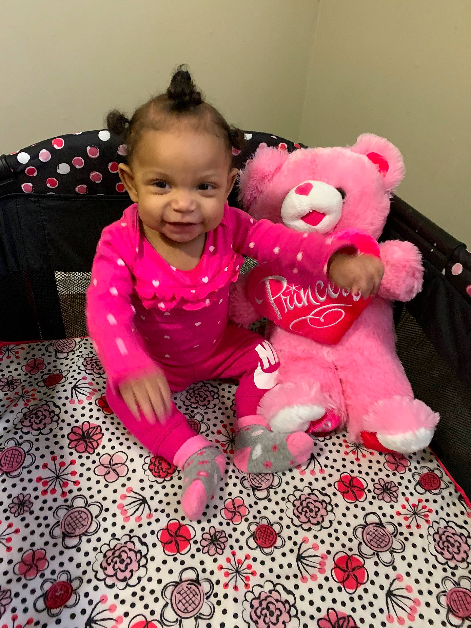 Lorianna is registered to the contest to win money with this photo: baby, child, furniture, magenta, pattern, person, pink, play, plush, room, skin, smile, stuffed_toy, teddy_bear, textile, toddler, toy