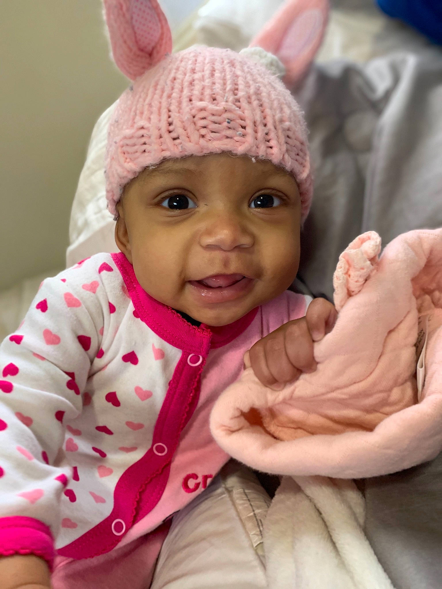 Lorianna is registered to the contest to win money with this photo: baby, cheek, child, ear, eye, finger, hand, head, headgear, headwear, organ, person, pink, skin, thumb, toddler