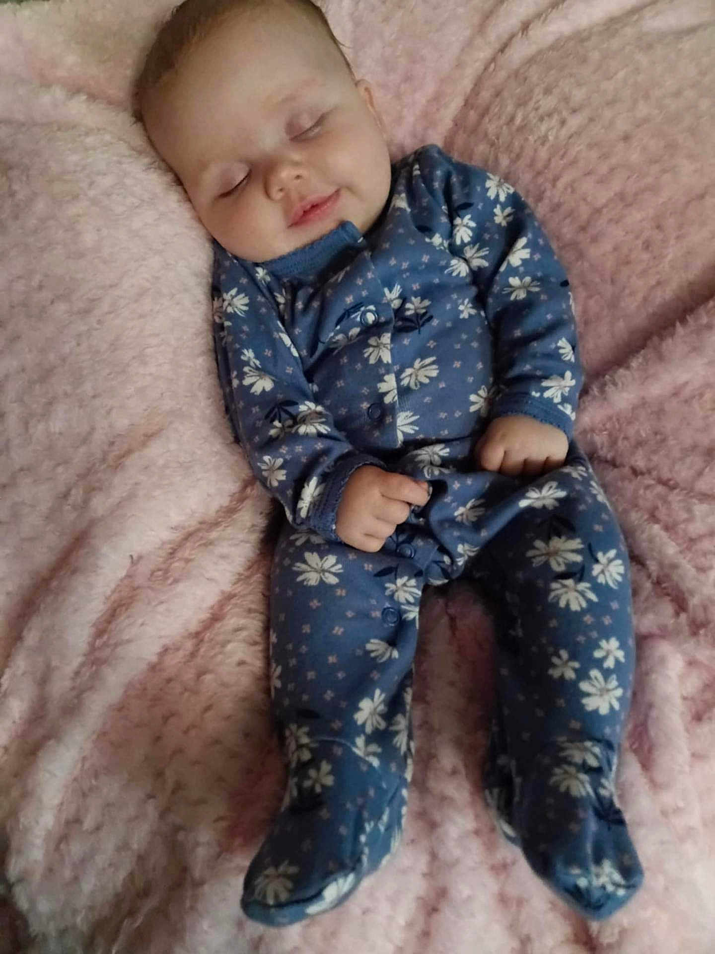 Calena joined the competition — help win amazing prizes! baby, sleeping, onesie, blue, floral, blanket, pink, soft, cozy, infant, child, peaceful, cute, clothing, person, portrait, resting, indoors, cute_face, small_hands