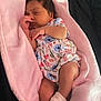baby, sleeping, blanket, pink, floral_dress, infant, child, cute, soft, cozy, newborn, person, resting, hand, socks, skin, peaceful, indoors, portrait, toddler