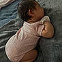 baby, sleeping, infant, blanket, pink_clothing, mittens, soft_texture, curled_up, indoors, cozy, child, cute, resting, peaceful, newborn, human, portrait, toddler, nap, skin