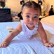 Zoe is registered to the contest to win money with this photo: baby, infant, pigtails, bed, white_bedspread, crawling, face, blue_eyes, expression, room, fan, dresser, hair, child, cute, home, furniture, portrait, curious, person