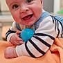 Raphaël participe au concours pour gagner de l'argent avec cette photo : baby, infant, smiling, blue_ball, orange_blanket, striped_sweater, lying_on_tummy, hands, close_up, portrait, indoors, big_eyes, open_mouth, cheeks, soft_texture, cute, playful, toy, happy, nursery